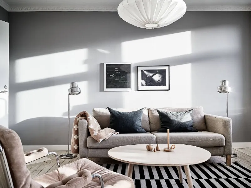 Neutral upholstered sofa and light wood coffee table for Scandinavian apartment hotel living room