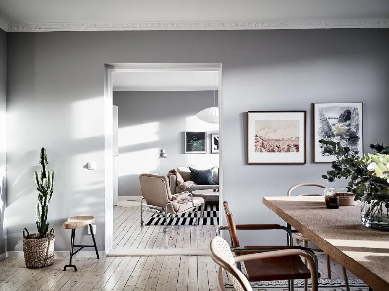 Open-plan apartment hotel dining and living areas with coordinated Scandinavian furniture