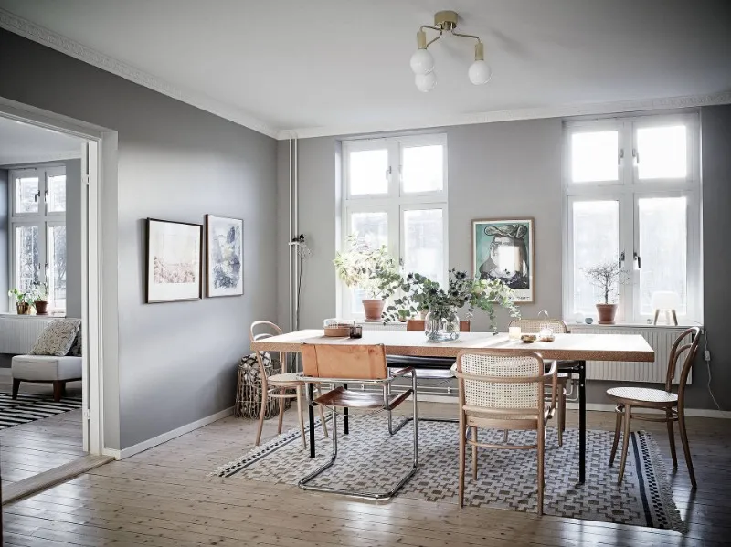 Scandinavian apartment hotel dining room with mixed wood, cane and leather seating