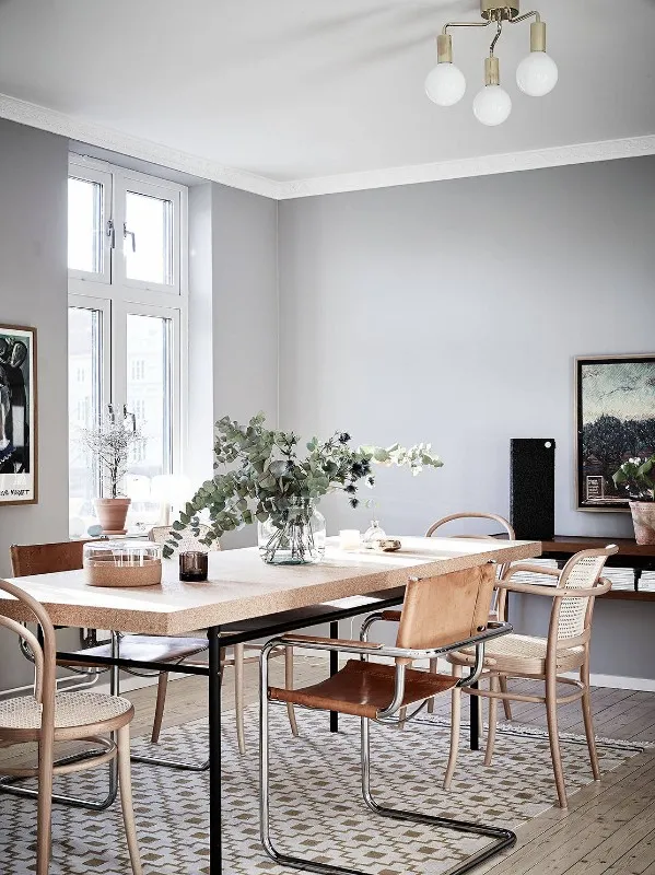 Detail view of Scandinavian dining furniture with wood, cane and leather finishes