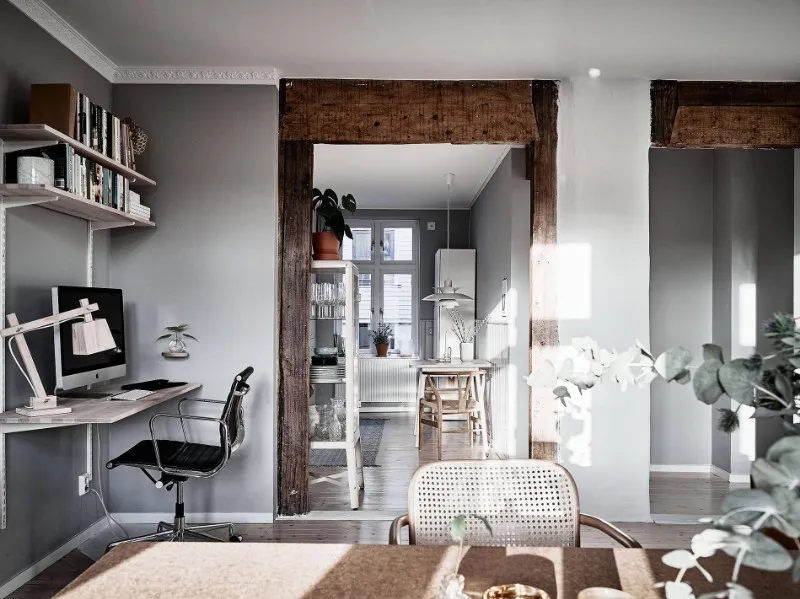 Apartment hotel workspace with wall-mounted desk, shelving and task chair